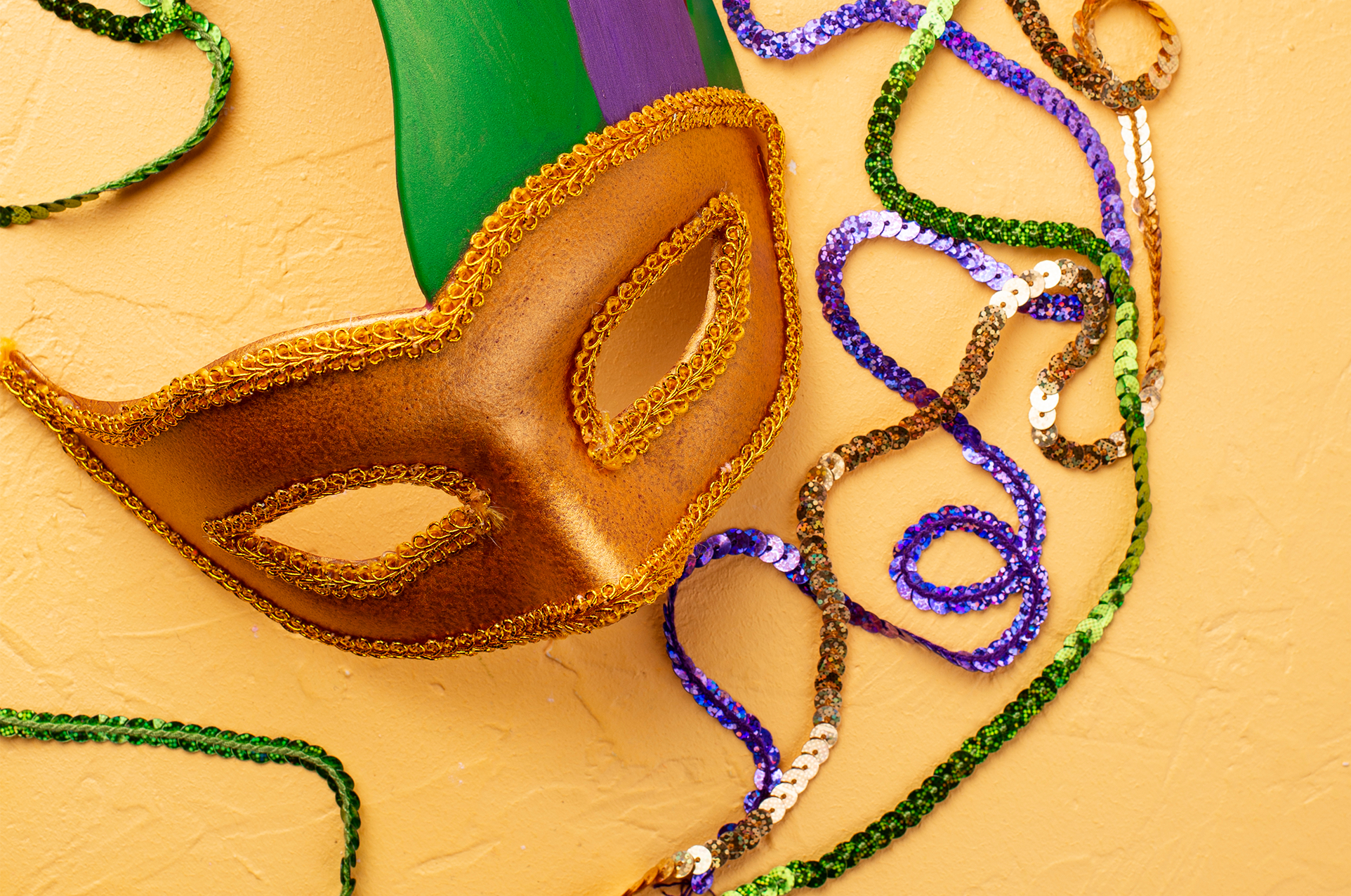 Carnival masks in purple, green and gold color. Mardi Gras background by Yuliya Furman